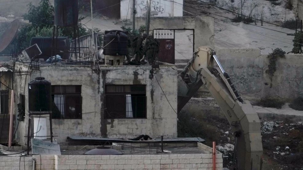 Video footage shows Israeli soldiers pushing bodies off a rooftop